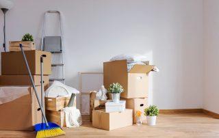 a broom in front of a pile of boxes.